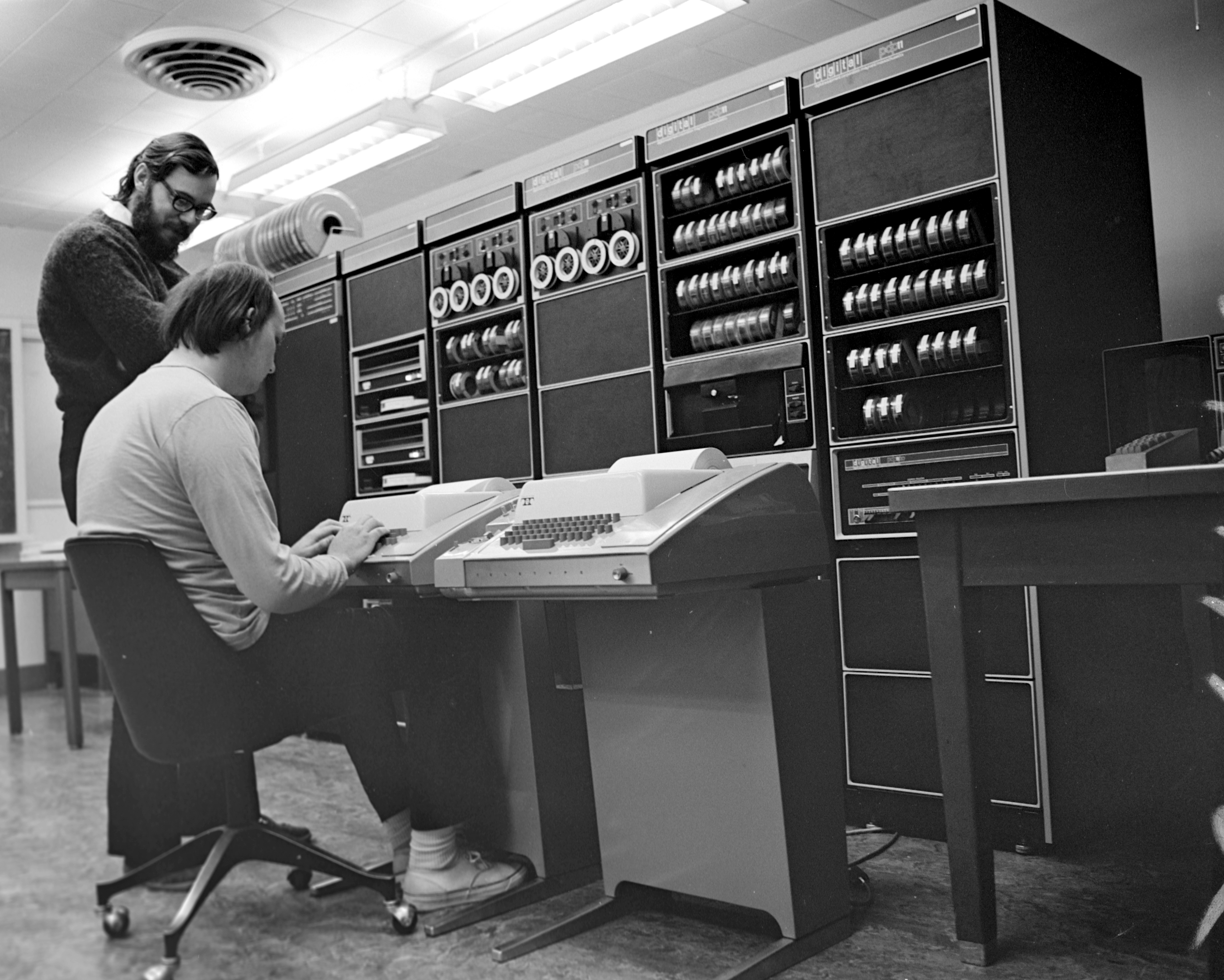 Dennis Ritchie (standing) and Ken Thompson (sitting) working on Unix.